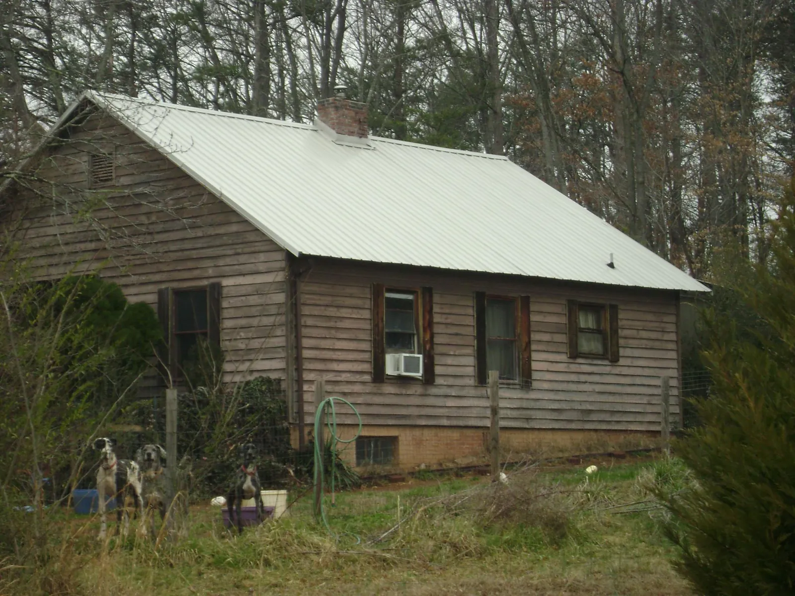White metal roof on an old wood sided farmhouse, from a Metal Roof Installation job in Devine